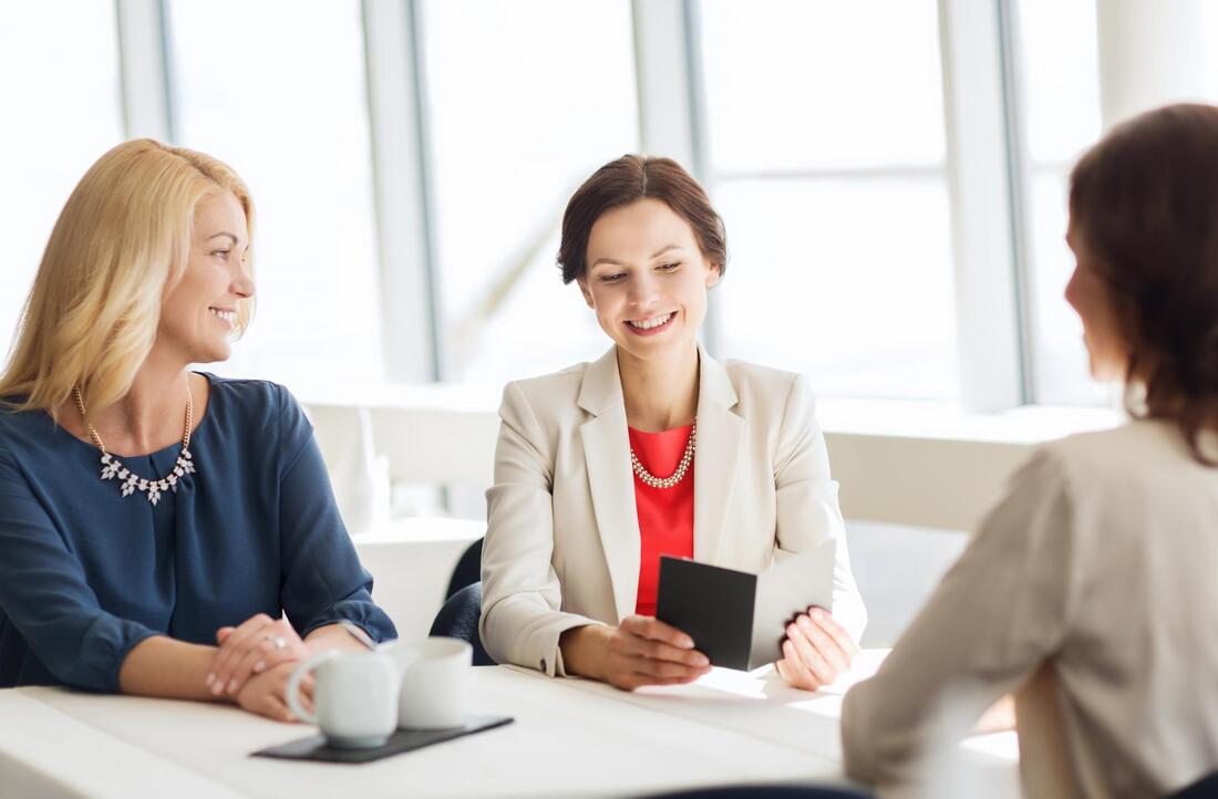 three women smiling talking 