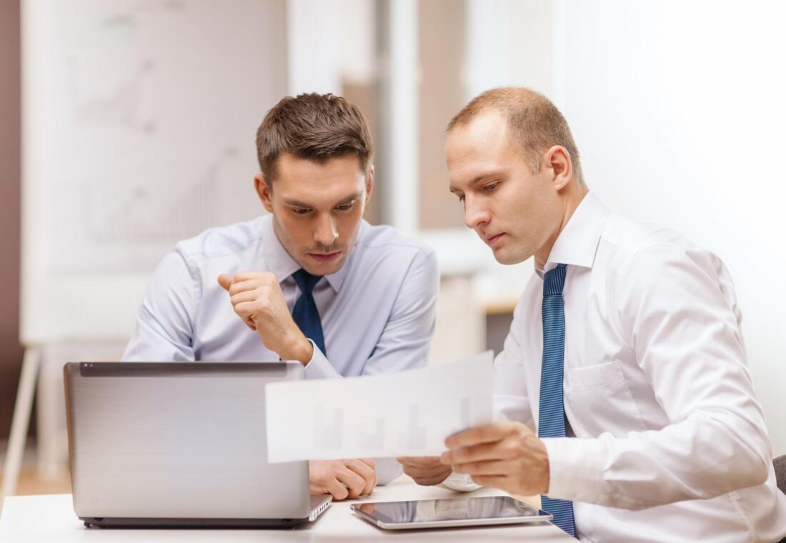 two employees working documents
