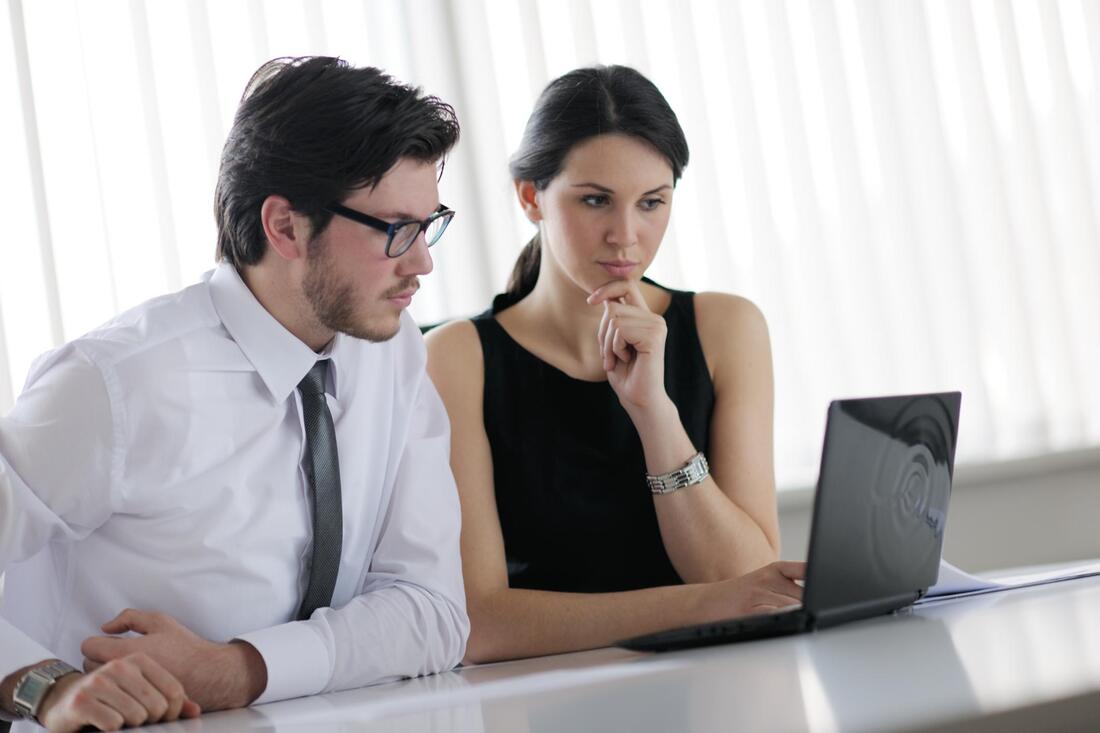 man woman looking at laptop